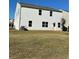 Back exterior of two-story home with backyard lawn at 136 Paulownia Cir, Mcdonough, GA 30253
