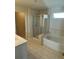 Bright bathroom showcasing a glass-enclosed shower and a separate soaking tub at 136 Paulownia Cir, Mcdonough, GA 30253