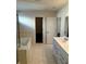 Bathroom view showing a glass shower, soaking tub, and dual sinks at 136 Paulownia Cir, Mcdonough, GA 30253