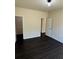Bedroom with dark wood floors, walk-in closet, and neutral walls for a relaxing ambiance at 136 Paulownia Cir, Mcdonough, GA 30253