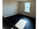 Spacious bonus room with a window letting in ample natural light and dark wood flooring throughout at 136 Paulownia Cir, Mcdonough, GA 30253