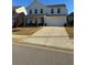 Charming two-story home with a well-manicured lawn, and a two car garage at 136 Paulownia Cir, Mcdonough, GA 30253