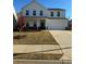 Charming two-story home with a well-manicured lawn, and a two car garage at 136 Paulownia Cir, Mcdonough, GA 30253