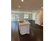 Open-concept kitchen with granite counters, stainless steel sink, and island with sink at 136 Paulownia Cir, Mcdonough, GA 30253