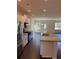 Modern kitchen with stainless steel appliances, granite counters, and white cabinetry at 136 Paulownia Cir, Mcdonough, GA 30253