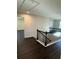 Second-floor landing area with sleek dark wood floors and modern railing at 136 Paulownia Cir, Mcdonough, GA 30253