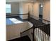Upstairs landing with dark wood floors, black railings, and bright natural light at 136 Paulownia Cir, Mcdonough, GA 30253