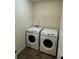 Functional laundry room with washer, dryer, and wire shelving at 136 Paulownia Cir, Mcdonough, GA 30253