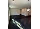 Spacious living room featuring sleek, dark wood flooring and ample natural light at 136 Paulownia Cir, Mcdonough, GA 30253
