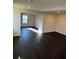 Open-concept living space highlighting dark wood floors and an abundance of natural light at 136 Paulownia Cir, Mcdonough, GA 30253