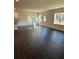 Bright and airy living area showcasing modern flooring and multiple windows for natural light at 136 Paulownia Cir, Mcdonough, GA 30253