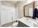 Modern bathroom with a walk-in shower, stylish vanity, and a framed mirror above the sink at 4311 Parkside Pl, Atlanta, GA 30342