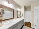 Bathroom featuring double vanity, framed mirrors, and marble shower at 4311 Parkside Pl, Atlanta, GA 30342