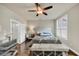 Bright bedroom with hardwood floors, neutral walls, ceiling fan, and bench at 4311 Parkside Pl, Atlanta, GA 30342