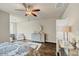 Bright bedroom with hardwood floors, neutral walls, ceiling fan, and dresser at 4311 Parkside Pl, Atlanta, GA 30342