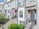 Charming townhome exterior with gray brick, a gray door, and an inviting entrance with steps at 4311 Parkside Pl, Atlanta, GA 30342