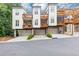 Exterior shot of newly built homes, each featuring private decks and attached garage parking at 4311 Parkside Pl, Atlanta, GA 30342