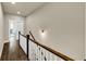 Upstairs hallway with wood floors, white railings, and natural light at 4311 Parkside Pl, Atlanta, GA 30342