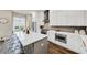 Bright kitchen with white cabinets, stainless steel appliances, island seating, and hardwood floors at 4311 Parkside Pl, Atlanta, GA 30342