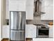 Kitchen area featuring stainless steel appliances, white cabinets, and a gray subway tile backsplash at 4311 Parkside Pl, Atlanta, GA 30342