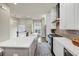 Open-concept kitchen featuring white cabinets, a long island, and stainless-steel appliances, with hardwood flooring at 4311 Parkside Pl, Atlanta, GA 30342