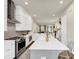 Modern kitchen with white cabinetry, stainless steel appliances, and a spacious gray island with seating at 4311 Parkside Pl, Atlanta, GA 30342