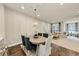 Open-concept living and dining area with hardwood floors, a modern chandelier, and comfortable seating at 4311 Parkside Pl, Atlanta, GA 30342