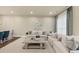 Spacious living room with neutral decor, stylish sofas, a decorative fireplace, and recessed lighting at 4311 Parkside Pl, Atlanta, GA 30342