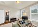 Well-lit home office space with an adjacent bathroom, complemented by a stylish glass desk and monitor at 4311 Parkside Pl, Atlanta, GA 30342