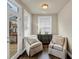 Bright sitting area with hardwood floors, view of deck, and outdoor light at 4311 Parkside Pl, Atlanta, GA 30342