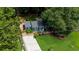 Aerial view showcasing the home, lush landscaping, and expansive driveway at 1718 Cahoon Sw St, Atlanta, GA 30310