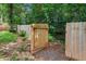 Wooden gate on the side yard provides backyard access and is surrounded by lush greenery at 1718 Cahoon Sw St, Atlanta, GA 30310