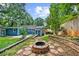 Backyard showing patio, fire pit, seating area and wooden storage building at the rear of the property at 1718 Cahoon Sw St, Atlanta, GA 30310
