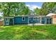 Spacious backyard with lush green grass, a patio, and an outbuilding at the rear of the house at 1718 Cahoon Sw St, Atlanta, GA 30310