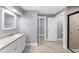 Modern bathroom with double sink vanity, granite countertop, and a glass shower at 1718 Cahoon Sw St, Atlanta, GA 30310
