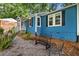 Charming blue home with stylish outdoor seating, complemented by lush landscaping at 1718 Cahoon Sw St, Atlanta, GA 30310
