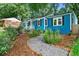 Charming blue home with a walkway, complemented by lush landscaping and stylish outdoor seating at 1718 Cahoon Sw St, Atlanta, GA 30310