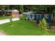 Charming home featuring a well-manicured lawn, fresh exterior paint and complementary landscaping at 1718 Cahoon Sw St, Atlanta, GA 30310