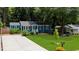 Charming home with a well-manicured front yard, large driveway, and vibrant landscaping at 1718 Cahoon Sw St, Atlanta, GA 30310