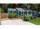 Charming home featuring a well-manicured lawn, fresh exterior paint and complementary landscaping at 1718 Cahoon Sw St, Atlanta, GA 30310