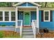 Inviting blue home featuring a charming front porch and a painted turquoise front door at 1718 Cahoon Sw St, Atlanta, GA 30310