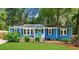 Charming blue home with a well-maintained front yard and a vibrant turquoise front door at 1718 Cahoon Sw St, Atlanta, GA 30310