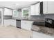 Well-appointed kitchen featuring granite counters, stainless steel appliances and white cabinetry, ideal for cooking and storage at 1718 Cahoon Sw St, Atlanta, GA 30310