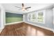 Bright living room boasts hardwood floors, statement wallpaper, and large windows, offering a vibrant and stylish space at 1718 Cahoon Sw St, Atlanta, GA 30310