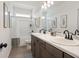 Bright bathroom featuring a double vanity with framed mirror and tiled shower and flooring at 48 Calla Dr, Douglasville, GA 30134