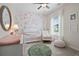 Charming Bedroom with floral wallpaper, crib, rocking chair, and decorative accents at 48 Calla Dr, Douglasville, GA 30134