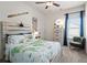 Comfortable bedroom with a ceiling fan, window, wooden bed frame, and decor at 48 Calla Dr, Douglasville, GA 30134
