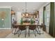 Open dining area with wood table, seating for six, and elegant light fixture with an eat in kitchen at 48 Calla Dr, Douglasville, GA 30134