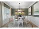 Elegant dining room with wainscoting, chandelier, and large windows for plenty of natural light at 48 Calla Dr, Douglasville, GA 30134