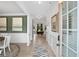 Bright entryway featuring light hardwood floors, white wainscoting, and views of the dining room beyond at 48 Calla Dr, Douglasville, GA 30134